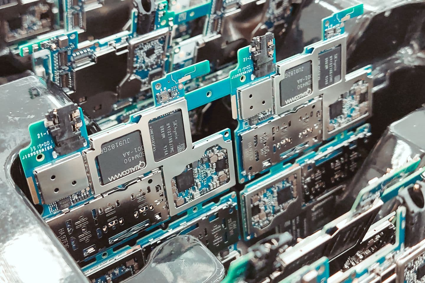 Rows of electronic circuit boards arranged in a production fixture.